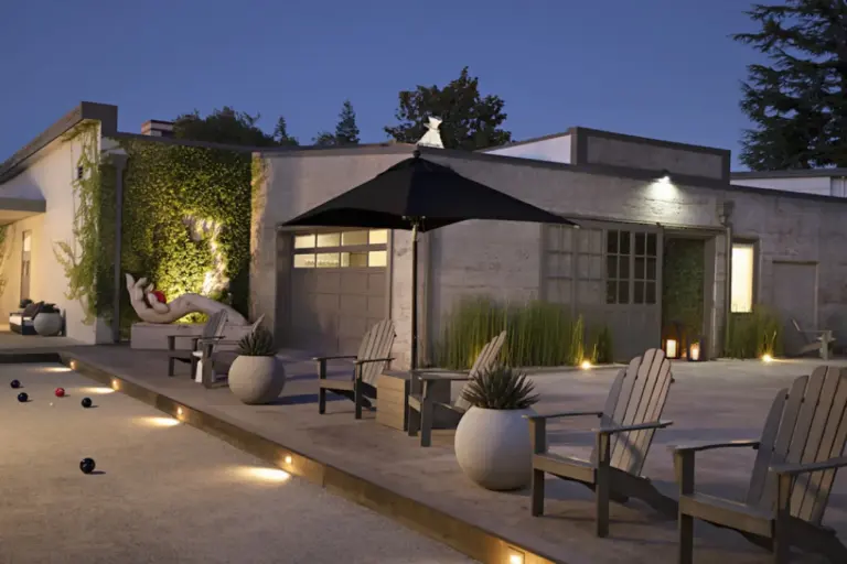 Outdoor patio and bocce court with in-ground lighting at dusk