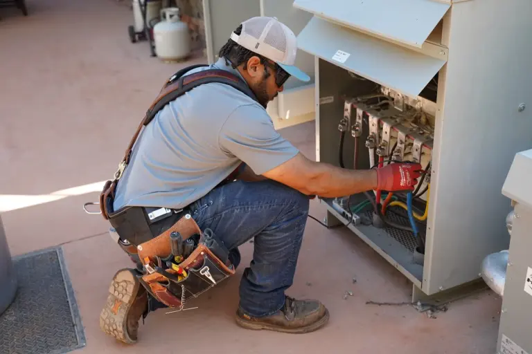 J&J Electric technician working inside an electrical panel