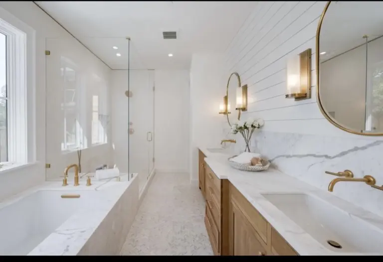 Primary bathroom with soaking tub and brass fixtures